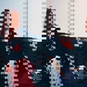 A young woman talking to a careers support adviser