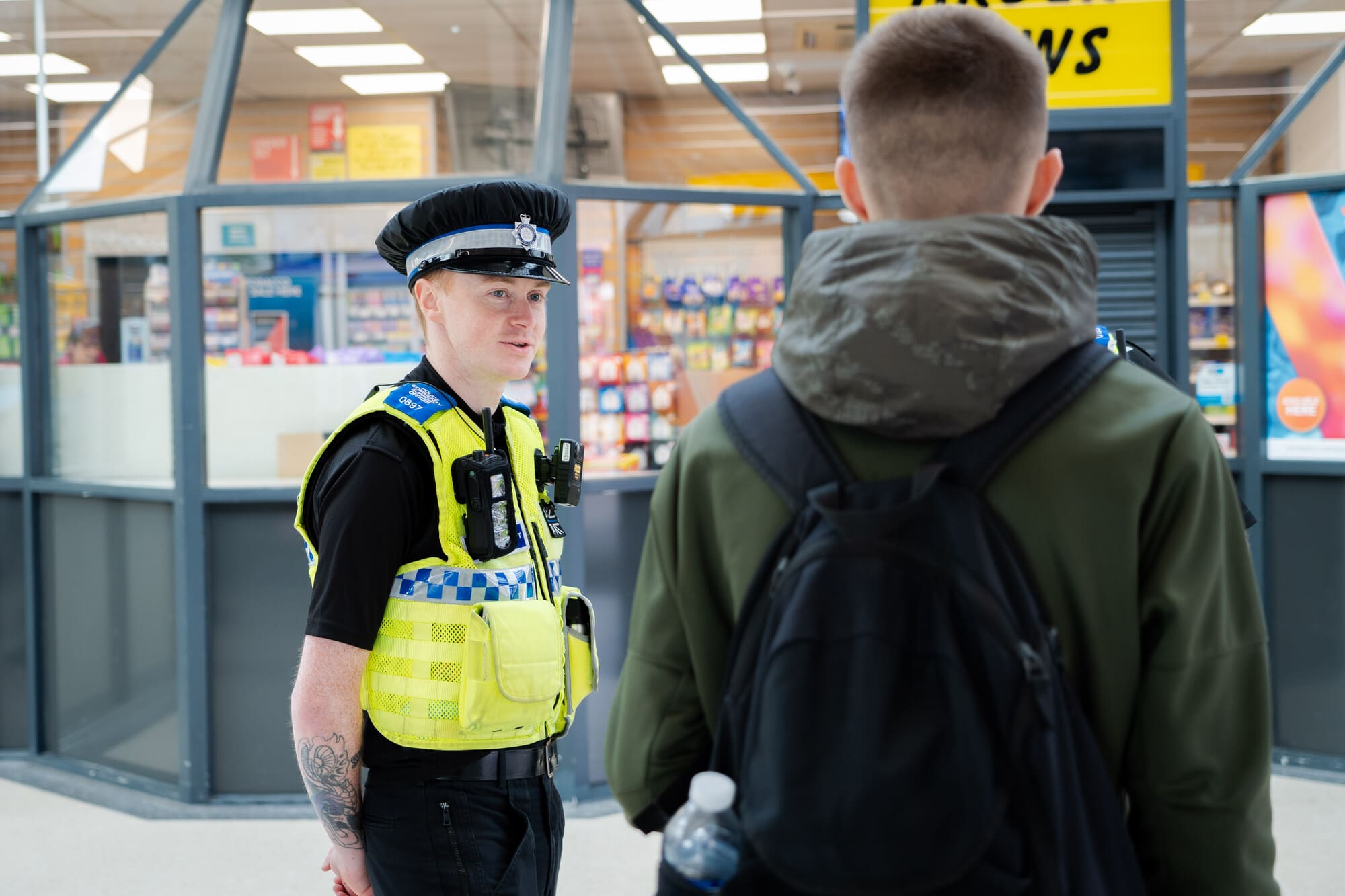 Uniformed police officer speaking to a member of public