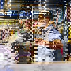 Man measuring out material at fabric shop