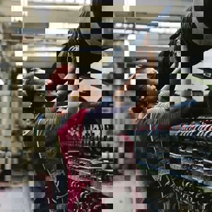 A woman weaving fabric on a machine