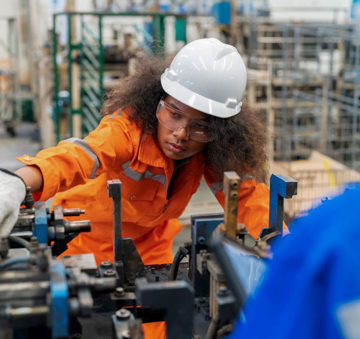 Female electrical engineer checking manufacturing parts