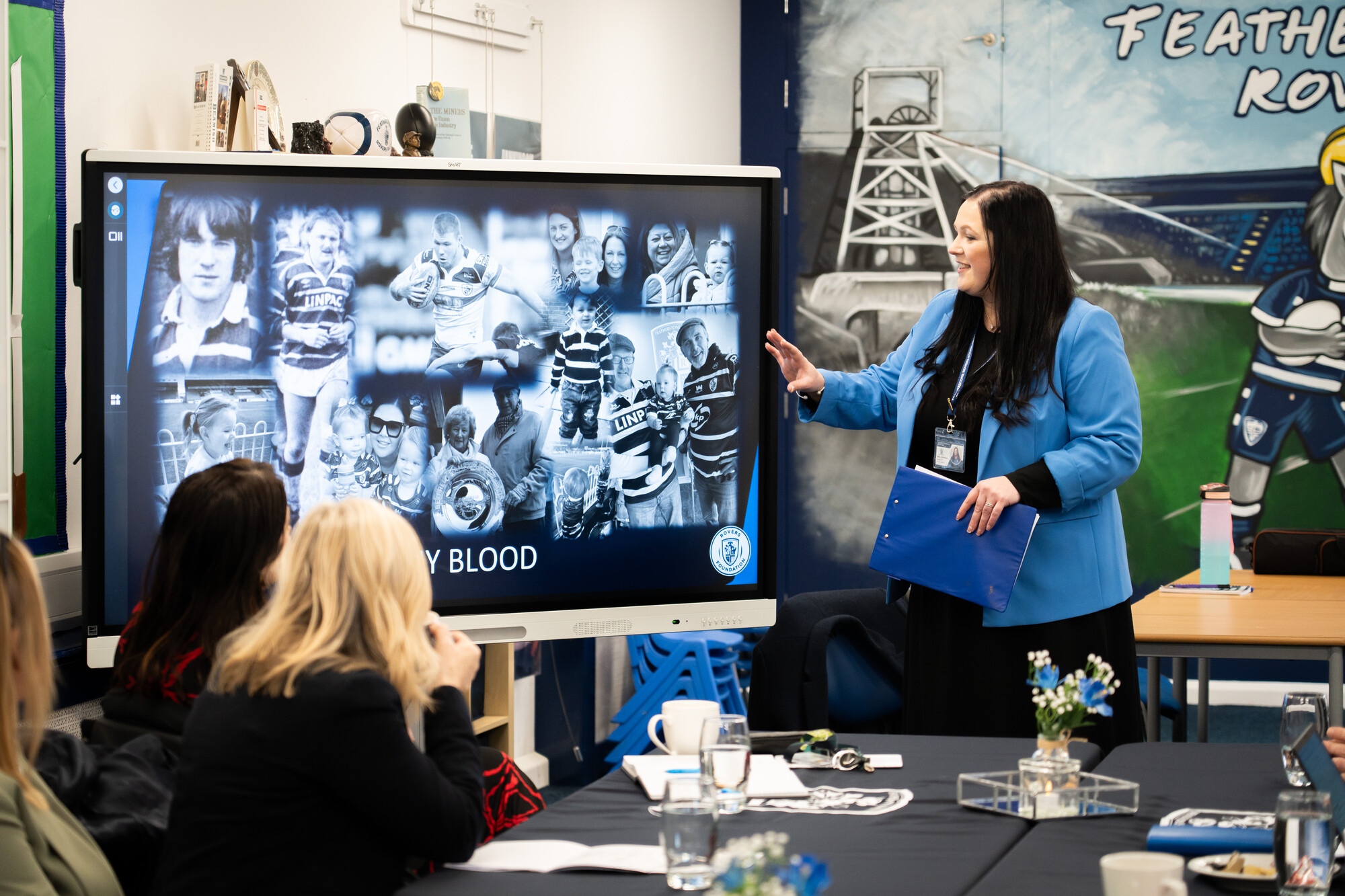 Educator points at screen to adult learners