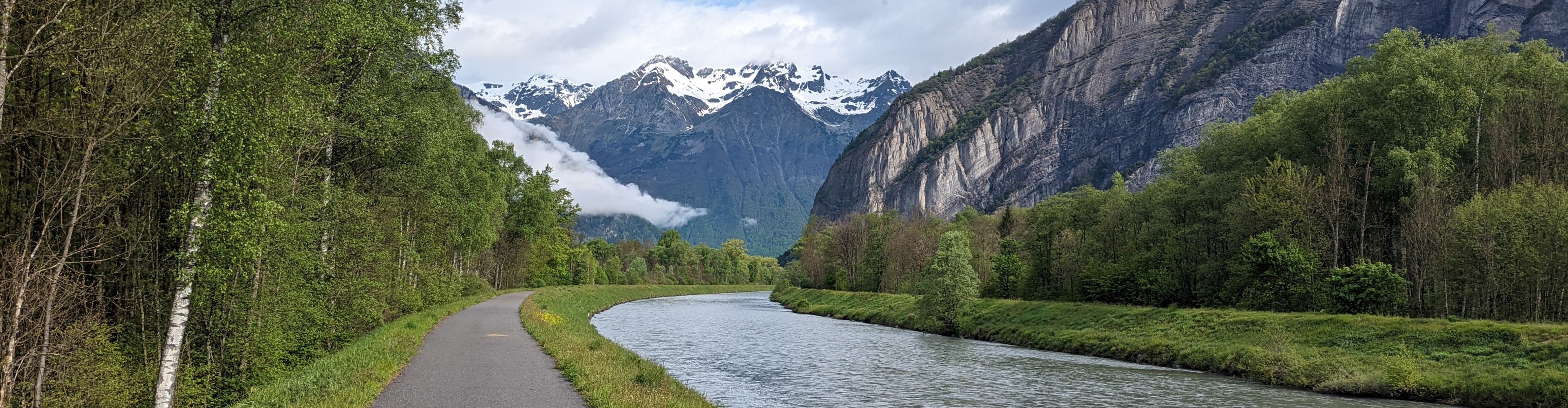 A road alongside a mountain lake