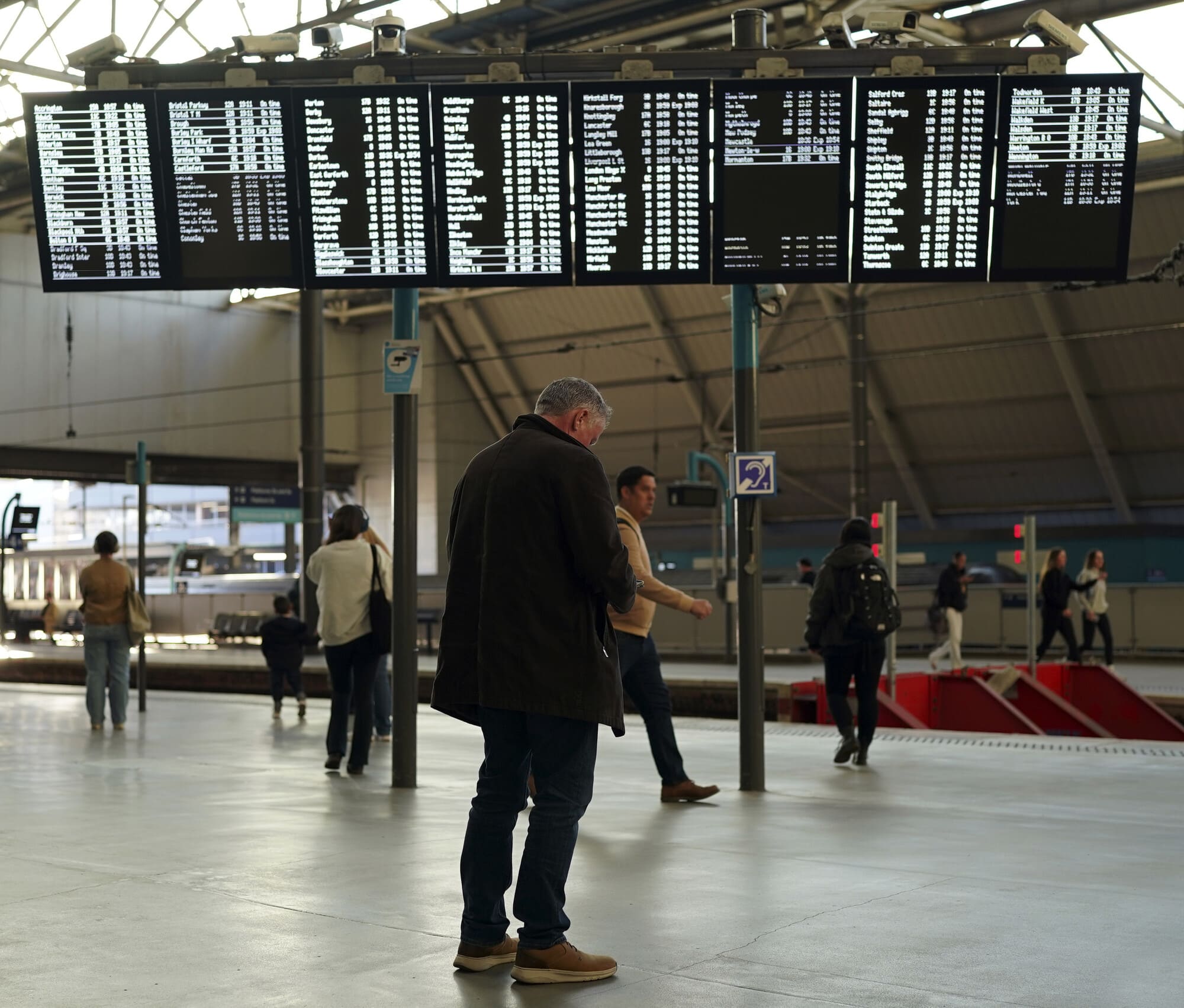 Man Standing In Leeds Train Station