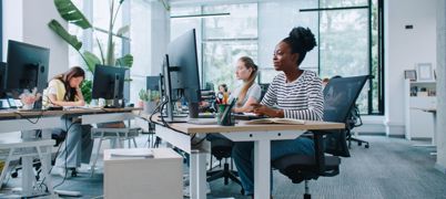 People Working At Computers In An Office