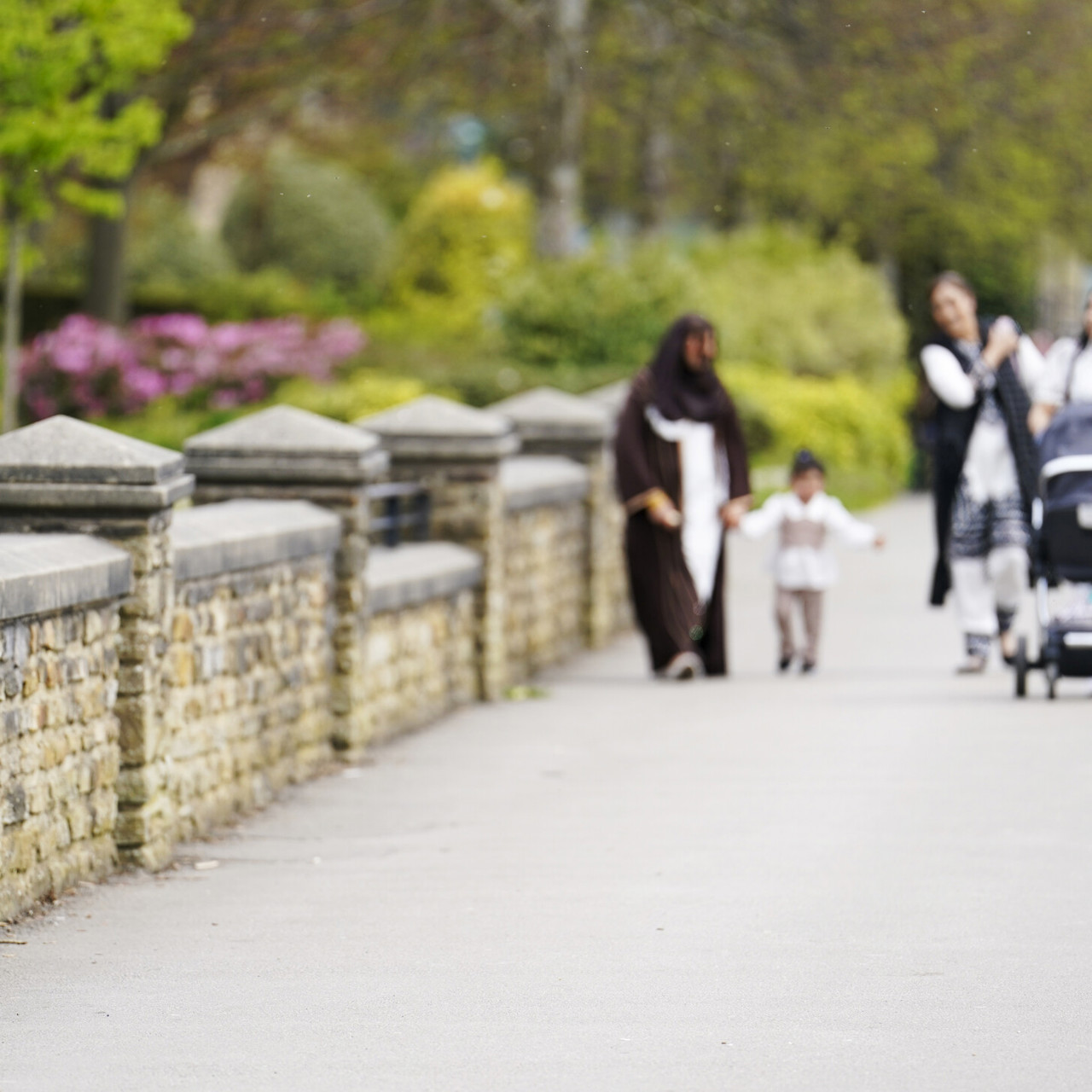 A family walking in Greenhead Park Huddersfield
