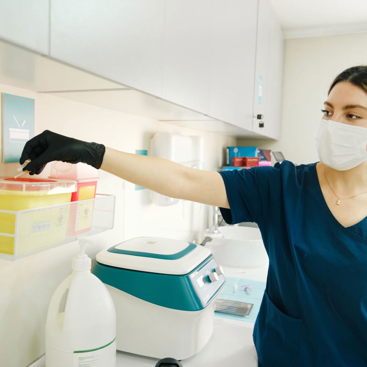 Dentist Disposing Medical Waste Into Yellow Safety Container