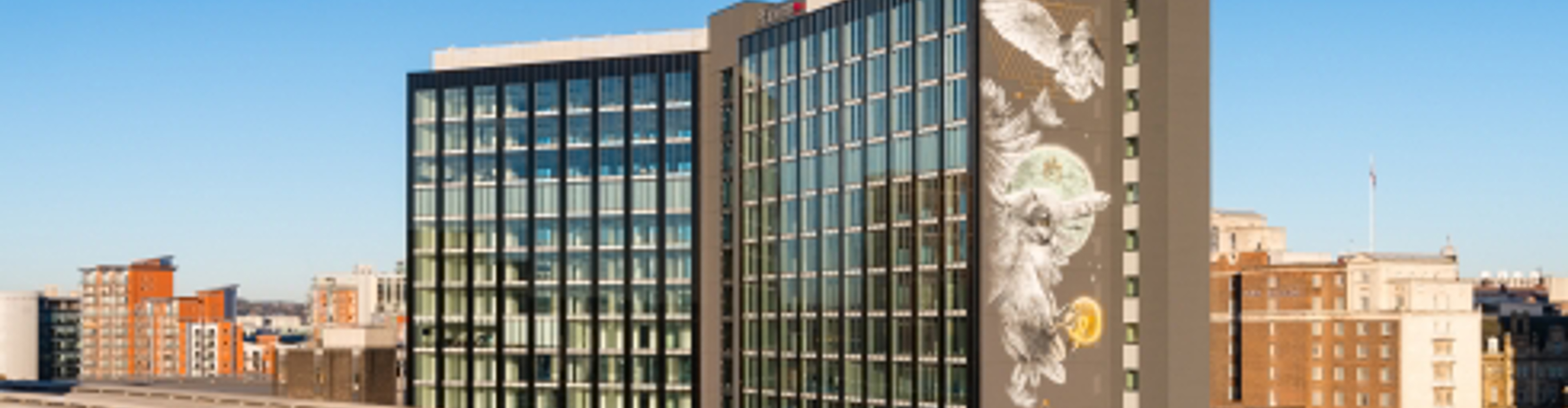 A high-rise building with art on the side