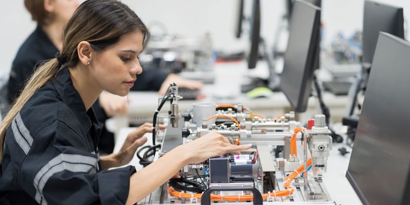 Female Engineer Training Programmable Logic Controller In The Laboratory Room